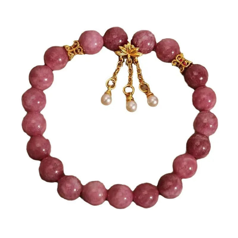 Pink and white natural stone bracelet with lotus flower pendant and tassel.