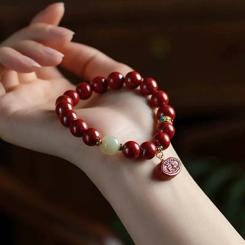 Natural cinnabar bracelet with Emperor sandstone design and Ping An Fu Lu motifs.