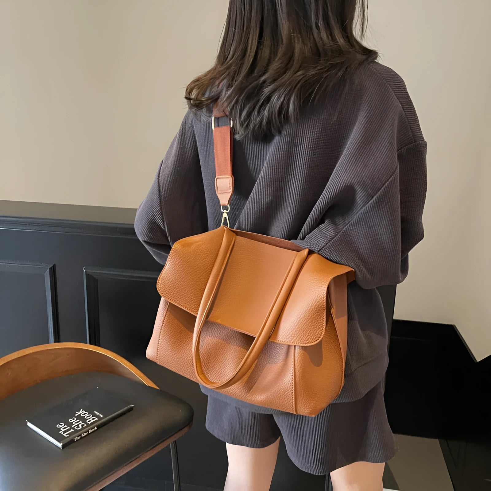 PU leather tote bag in beige with double shoulder strap and visible stitching detail.
