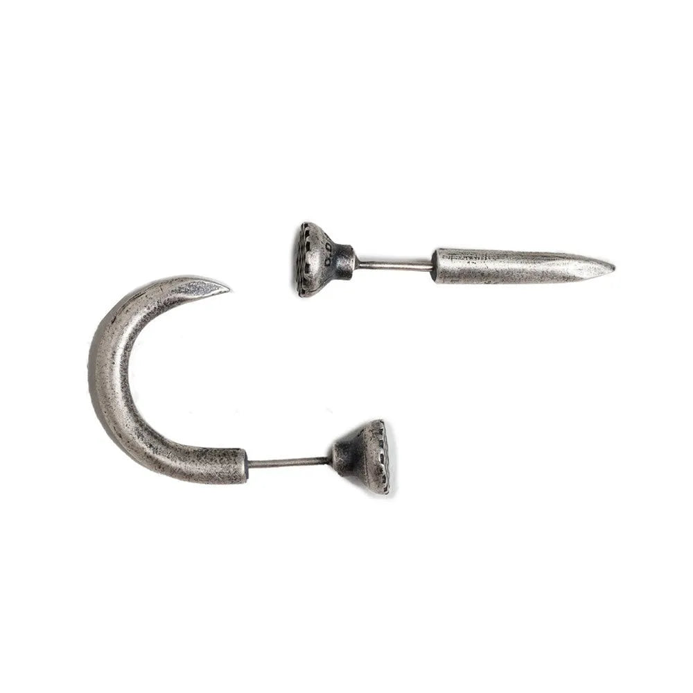 Close-up of a sterling silver S925 punk-style earring shaped like a retro nail, shown on a hook back.