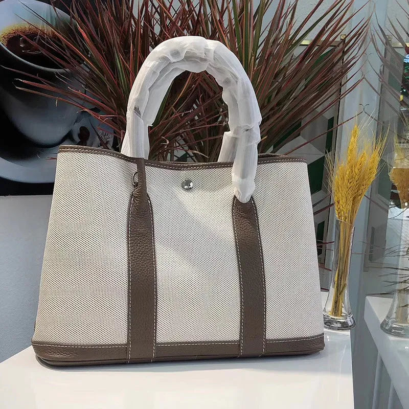 Genuine leather women's crossbody tote bag with canvas texture in bucket shape
