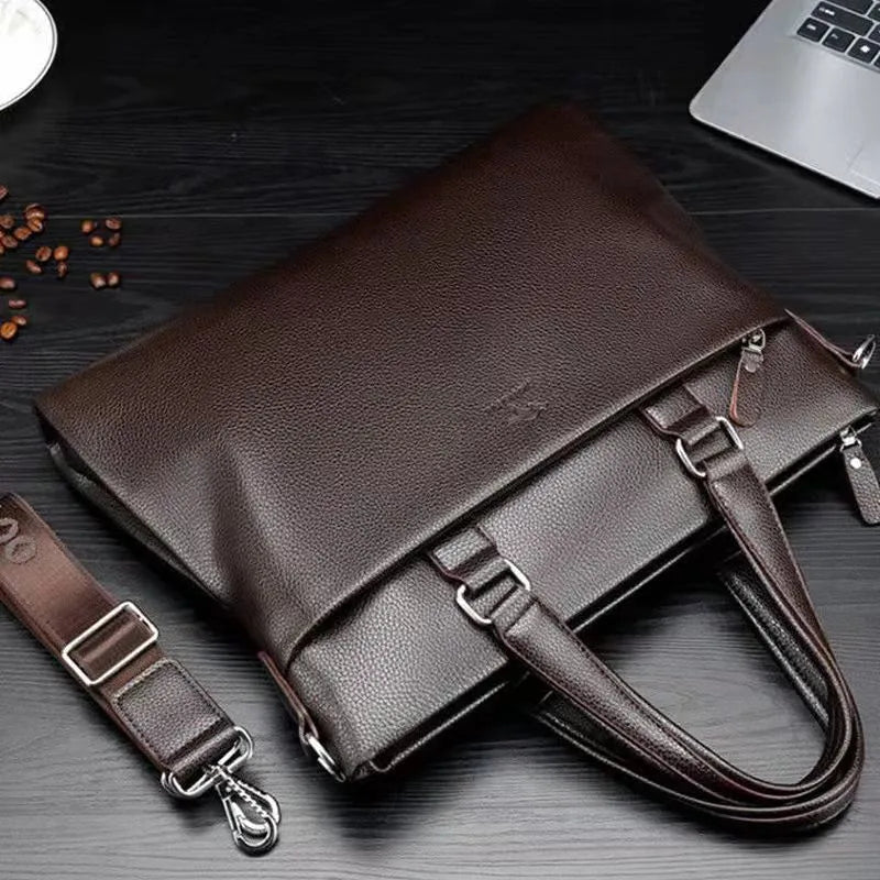 Men's black and brown PU leather business messenger bag with splicing design on a table.