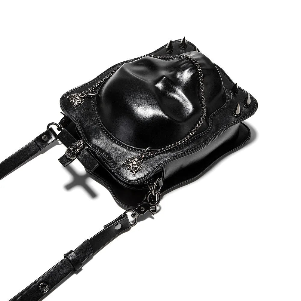 Black mini square crossbody bag with 3D embossed skull design, stitching details, and metal rivets