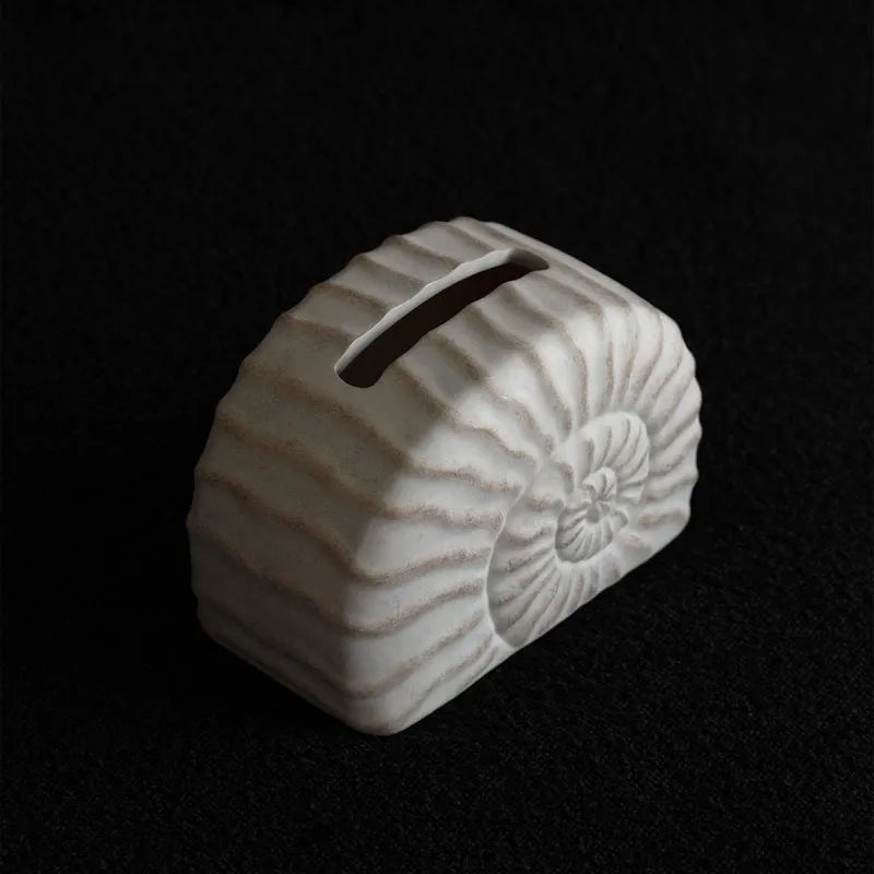 Conch ramble coloured resin decorative tissue box cover with a modern simple design.