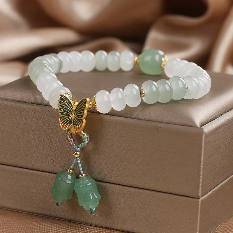 Green crystal women's bracelet with Tian Shan Cui abacus beads and retro butterfly tassel design