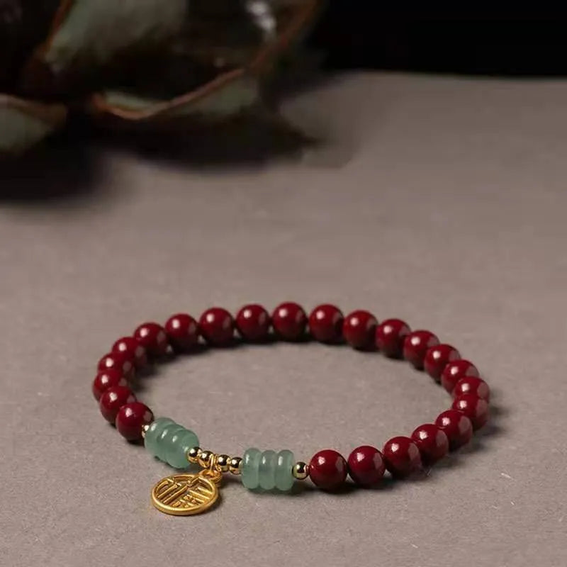 Gold cinnabar and copper wave bracelet in pumpkin or brand colour on wrist.