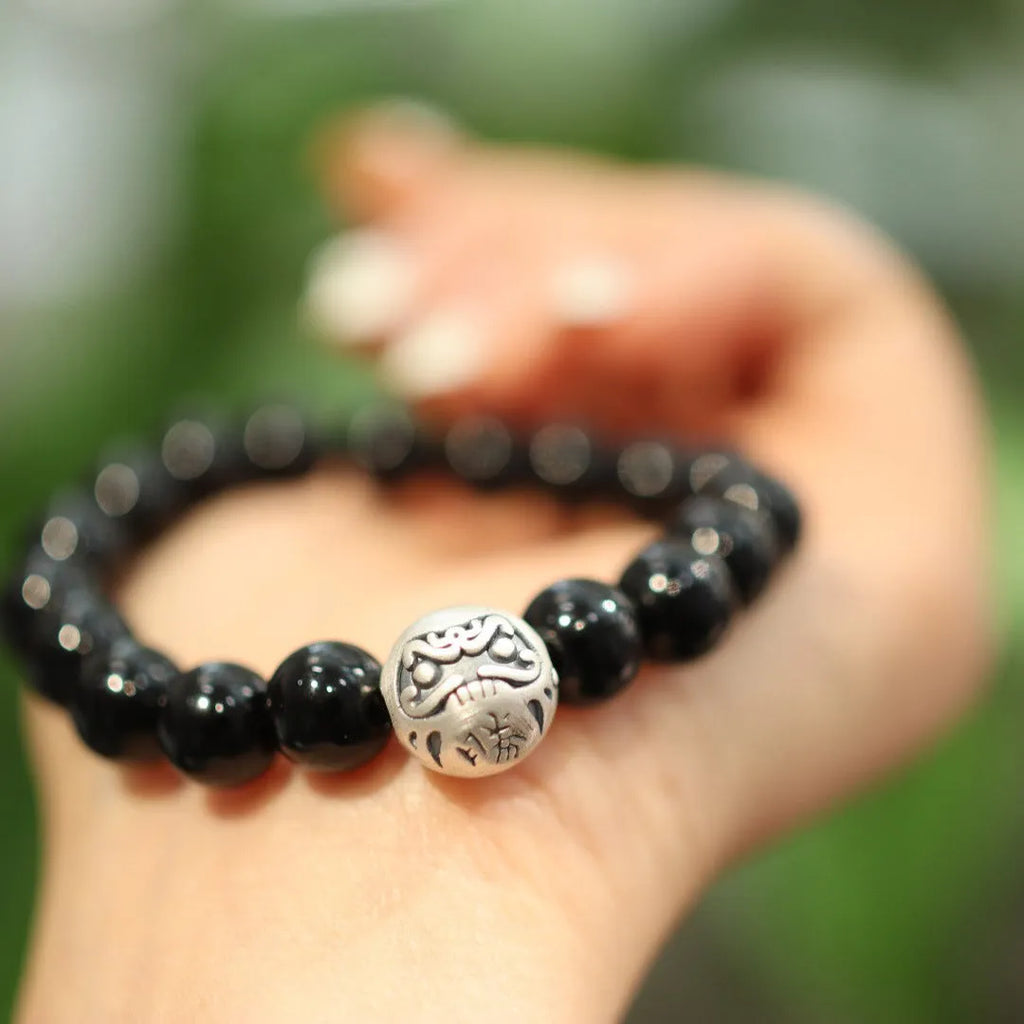 Black agate bracelet with 10mm beads and sterling silver clasp on wrist