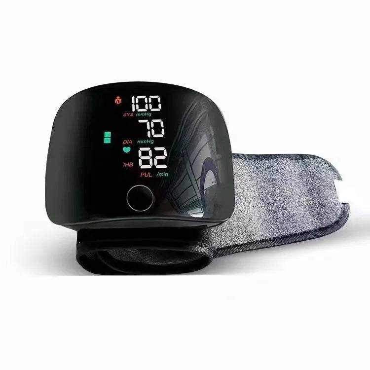 Black wrist blood pressure monitor with digital LCD screen and USB charging port