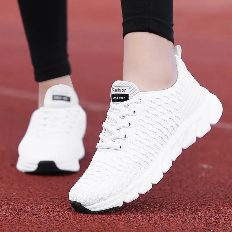 Women's running shoes with a fly weave upper in black, pink, and white colour options on a wear-resistant outsole.