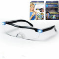 Transparent black USB LED light reading glasses on a table, showing the built-in light and frame.