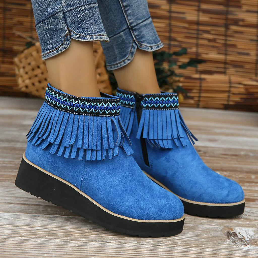 Women's dark brown suede ankle boot with wedge heel, side zipper, and decorative tassel.