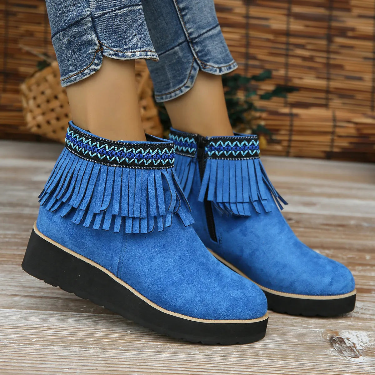 Women's dark brown suede ankle boot with wedge heel, side zipper, and decorative tassel.