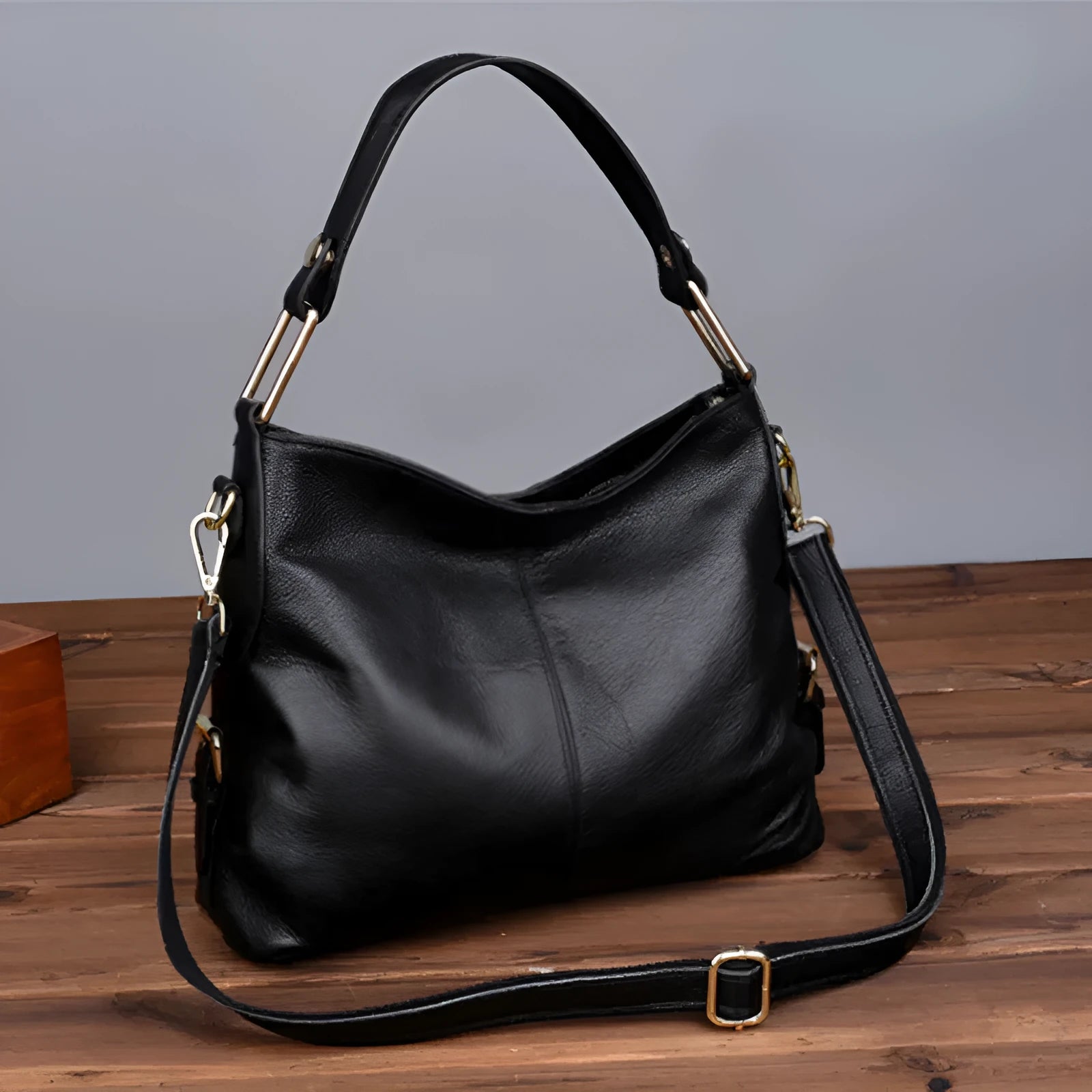 Square vertical genuine leather crossbody bag with multiple internal compartments including phone pocket.