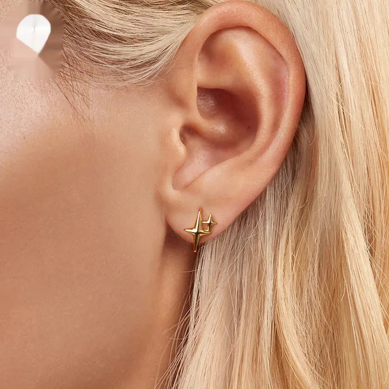 Minimalist oxidised sterling silver ear clips with geometric star designs