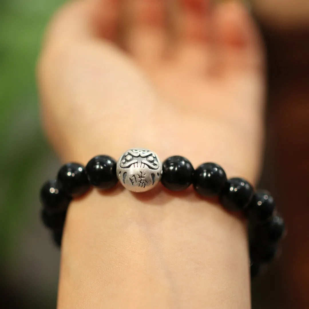 Black agate bracelet with 10mm beads and sterling silver clasp on wrist