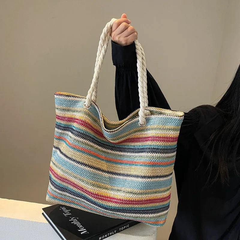 Blue woven nylon shoulder bag with straw-inspired basket construction and polyester lining