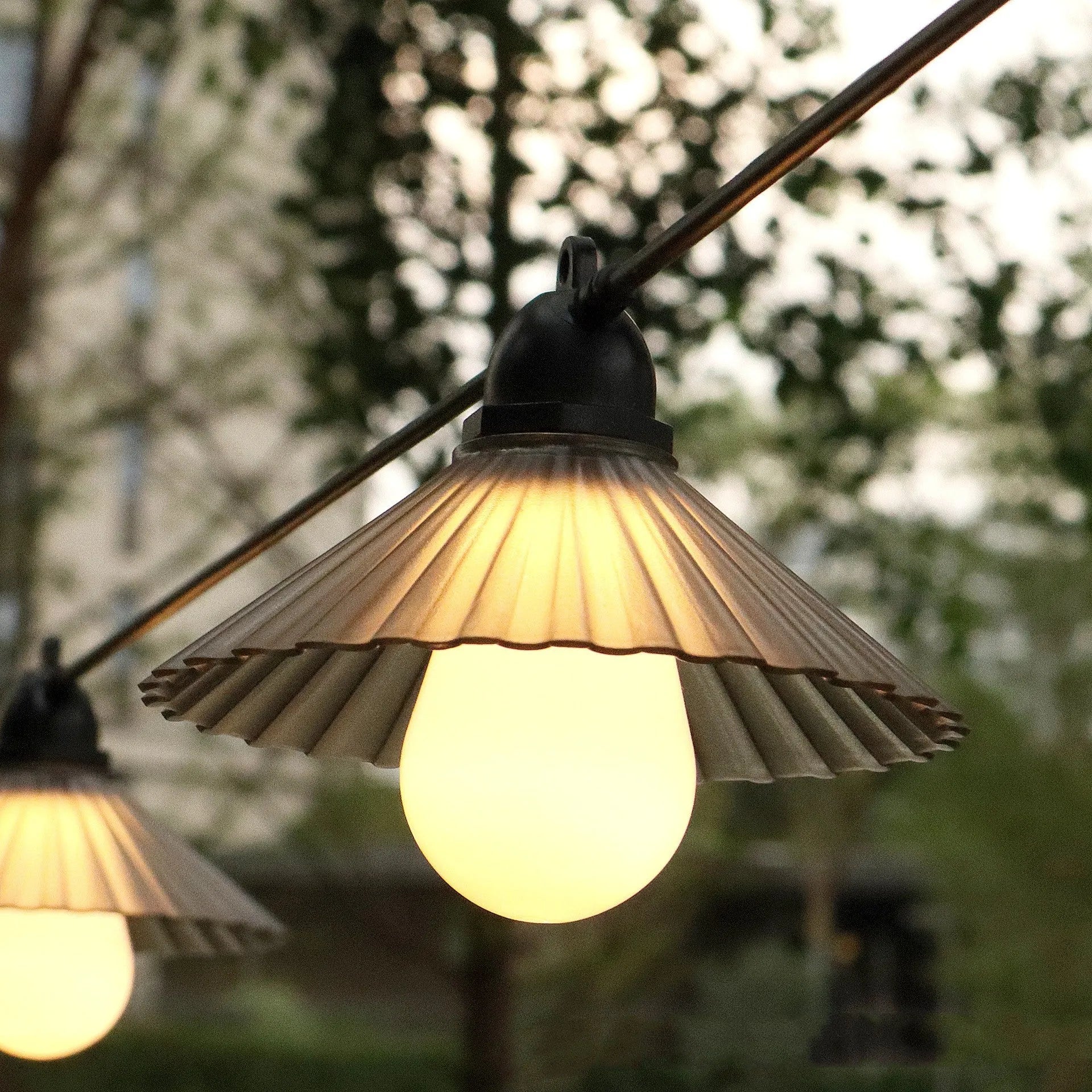 Outdoor LED string lights with flower-shaped bulbs in warm white and multicolour settings.