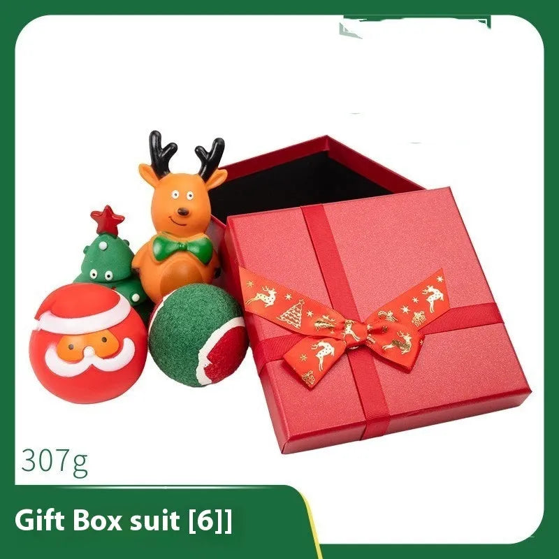 Seven Christmas gift bags containing vinyl dog toys with Santa heads, trees and deer figures