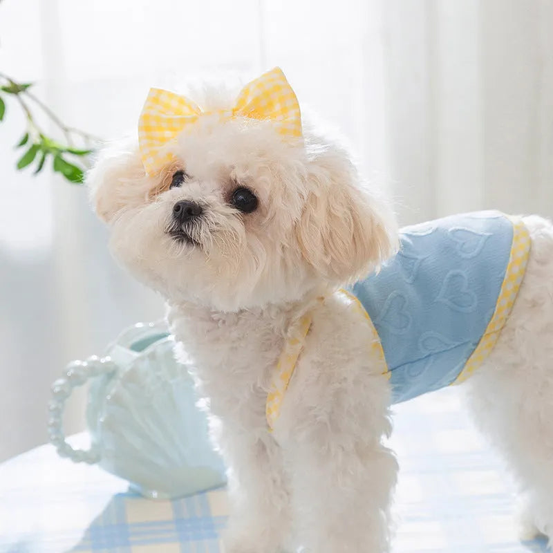 Small dog wearing heart bow suspenders vest in elastic material with decorative bow detail