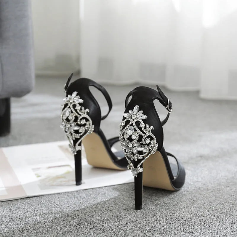Black suede women's high heel shoes with rhinestone detailing and a fish mouth toe.