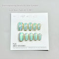 Set of electroplated Cat's Eye and aurora design false nails in short ladder XS, S, and M sizes.