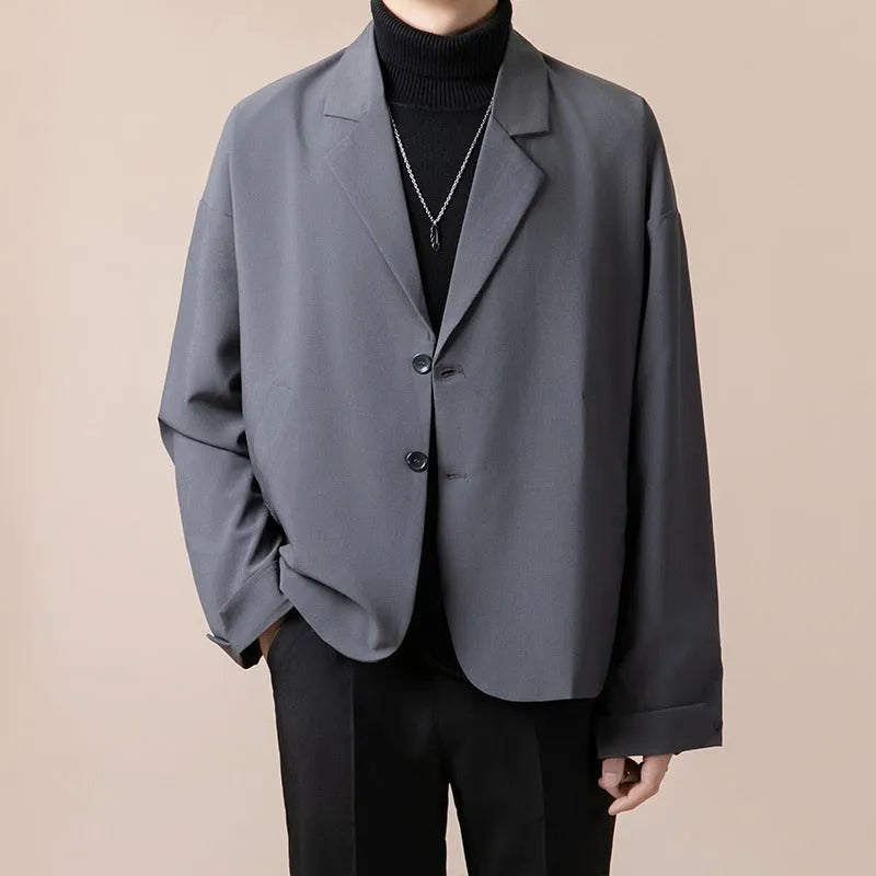 Loose fit light business suit jacket in chemical fibre blend fabric showing regular length and long sleeve design