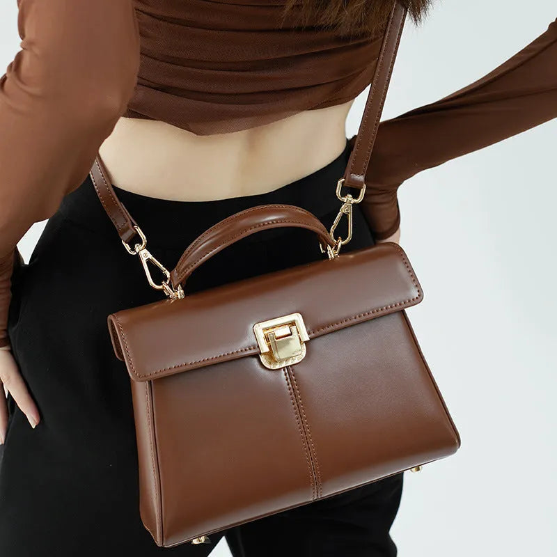 Women's genuine leather shoulder bag with vachette clasp in horizontal square design showing internal compartments