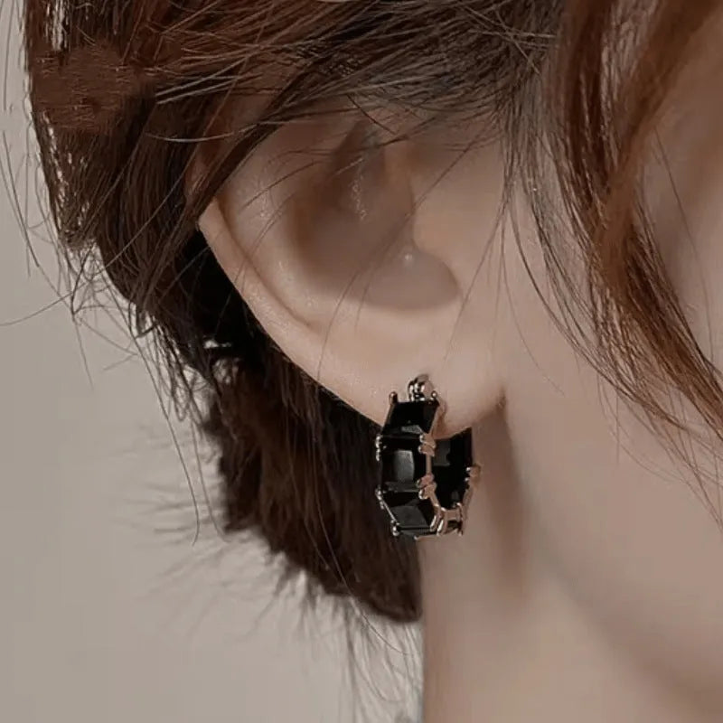 Geometric U-shaped gold earrings with black zircon crystal stones and round decorative elements
