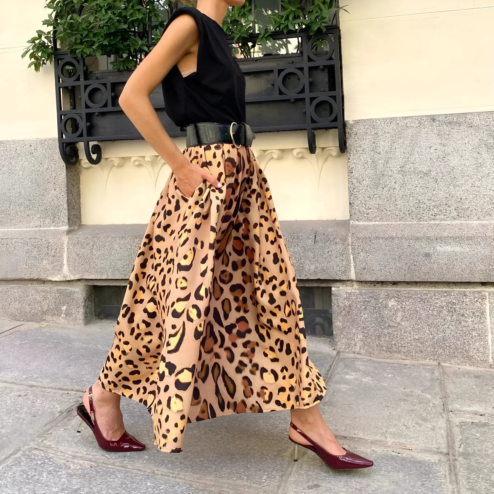 Women's brown leopard print A-line long skirt made from polyester fabric with an inelastic waist.