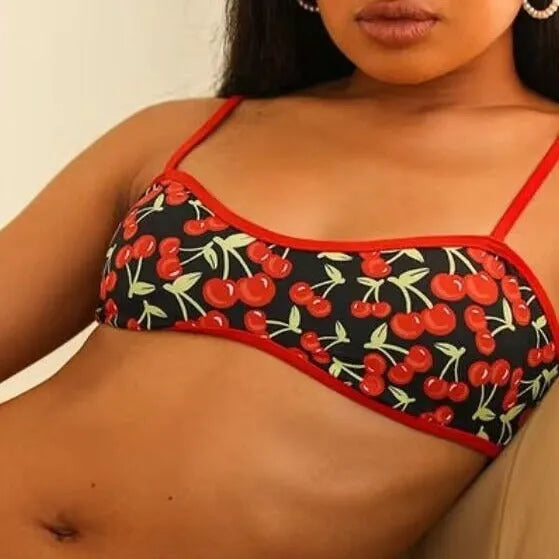 Women's cherry print tube top bikini swimsuit in brief style on a mannequin.