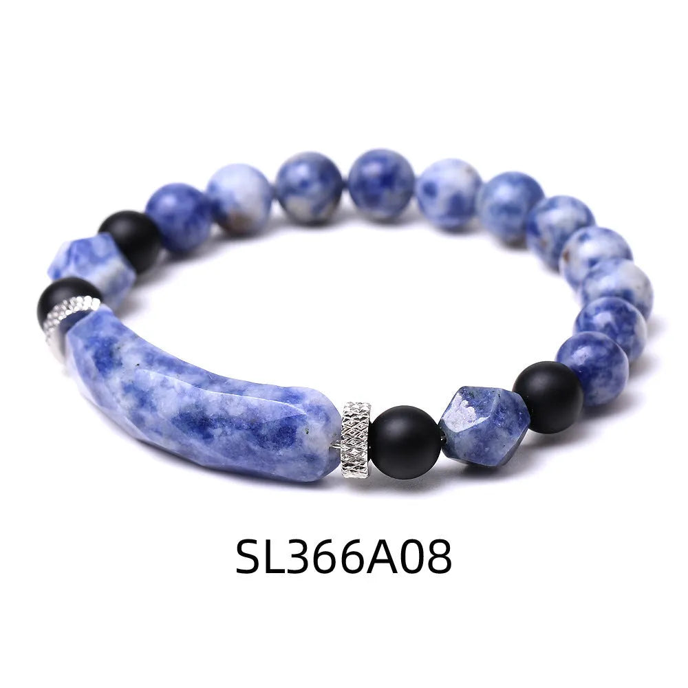 Handmade diamond-shaped cut agate bracelet in a geometric, fan-shaped design on a wrist.