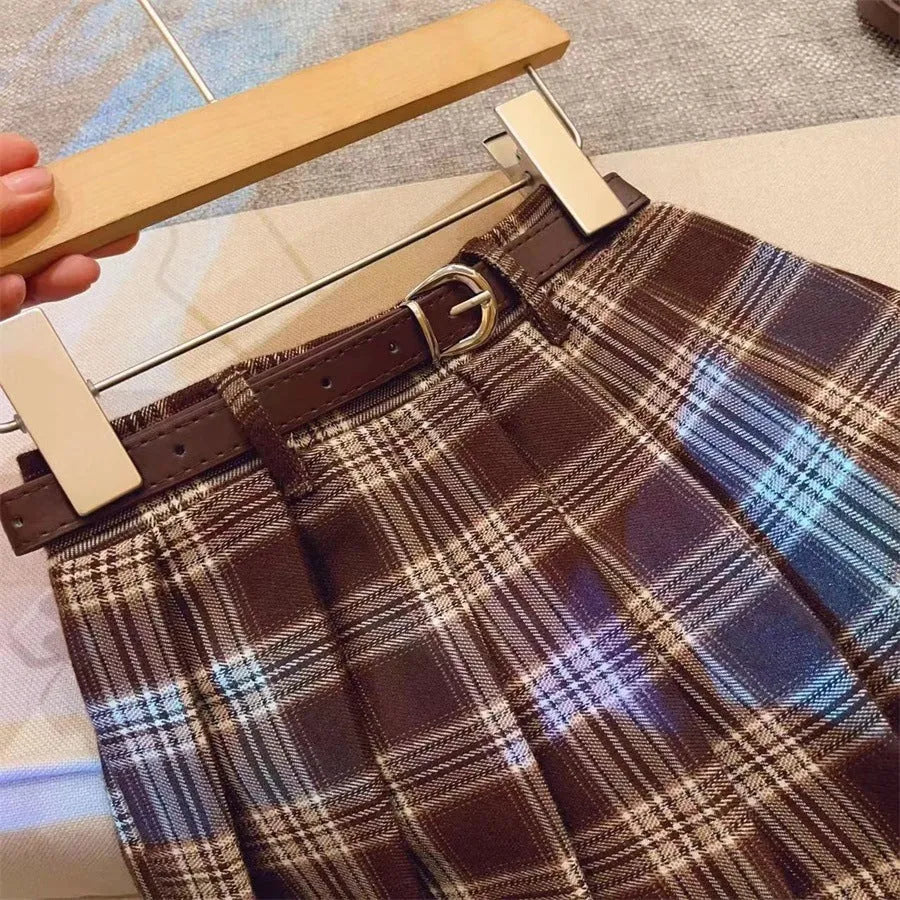 Girls plaid pleated A-line skirt in cotton blend fabric on hanger.