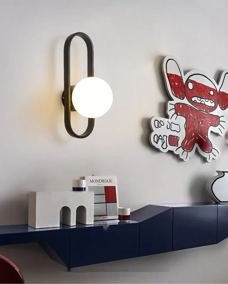 Minimalist wall-mounted lamp with glass shade and iron body in black finish