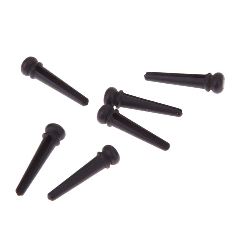 Six black matt ebony guitar bridge pins with solid string cone design