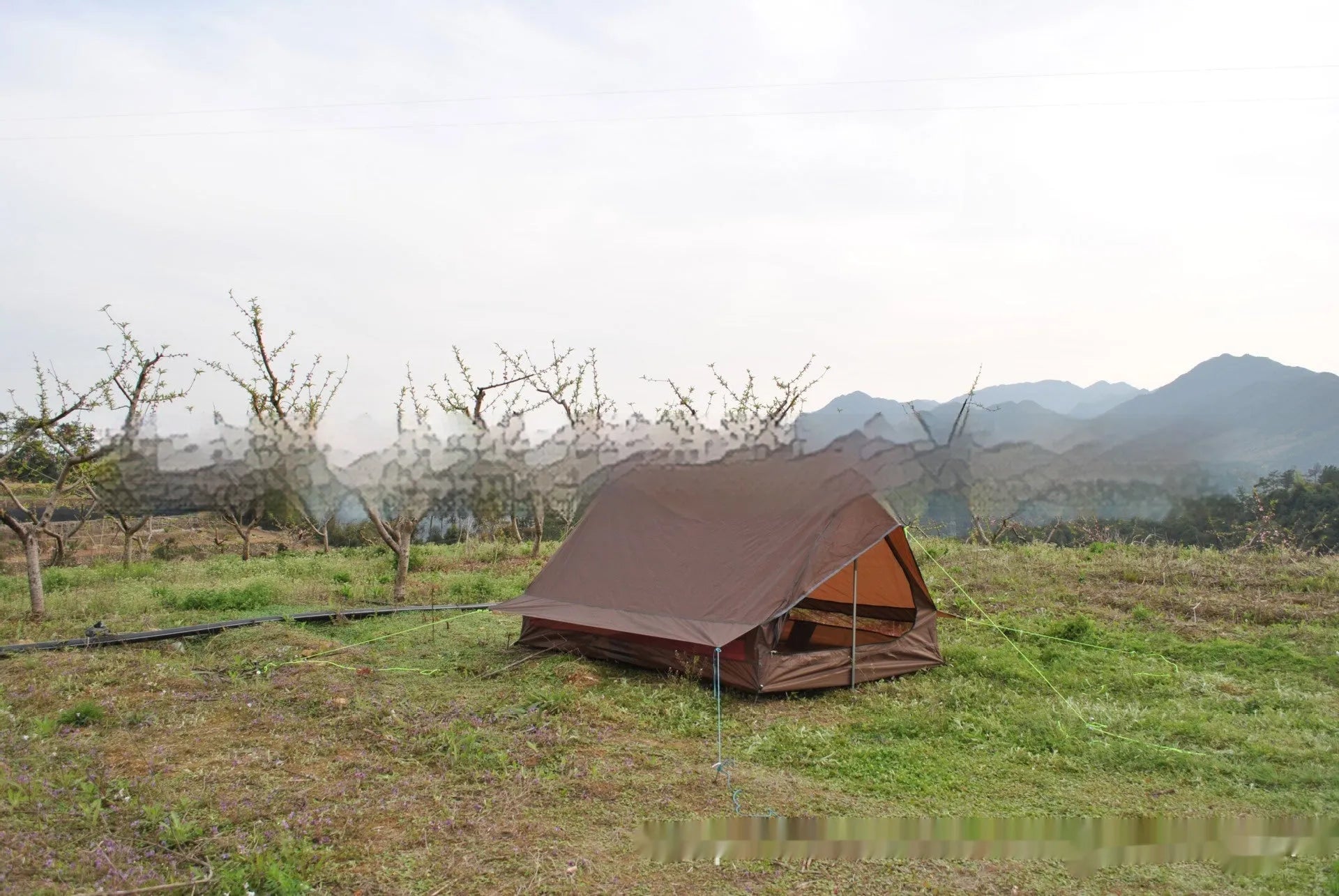 Brown A-line pole-free portable tent with hiking cane support showing interior space for 2-3 people