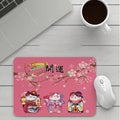 Custom cartoon design on a small black thickened mouse pad with stitching, shown on a desk.