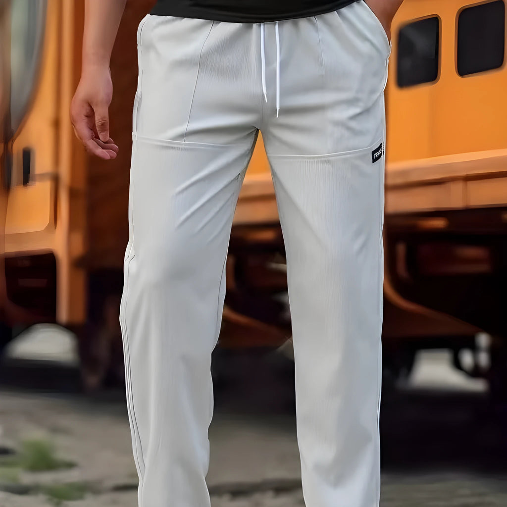 Men's casual polyester trousers for spring and autumn in light grey colour.