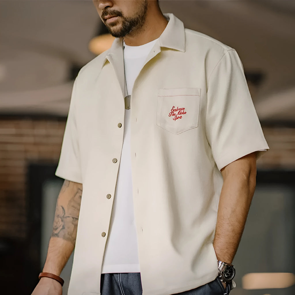 Men's light apricot shirt with botanical plant print and a Cuban collar.