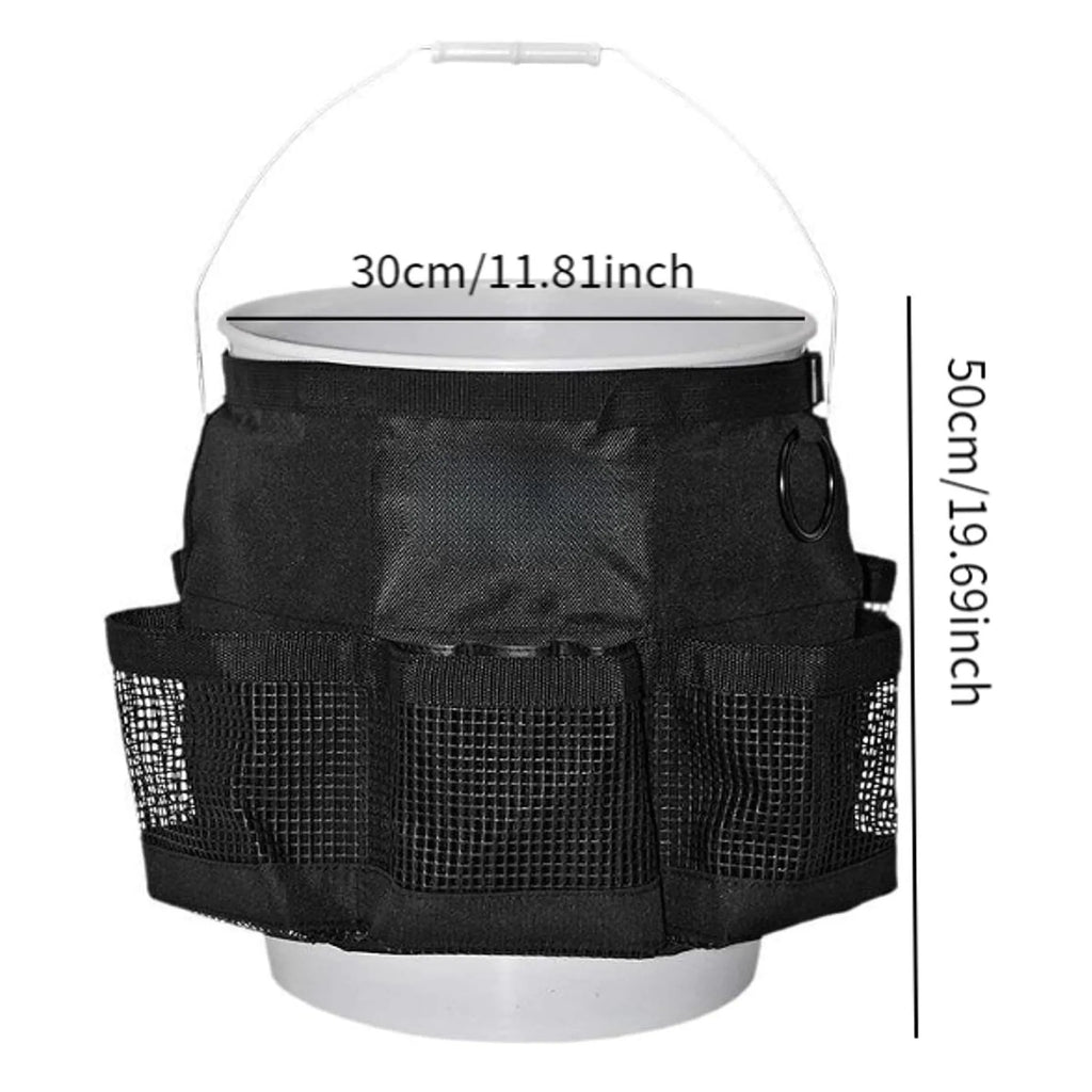 Black cylindrical polyester storage bag hanging on a 5-gallon barrel for outdoor tool organisation.