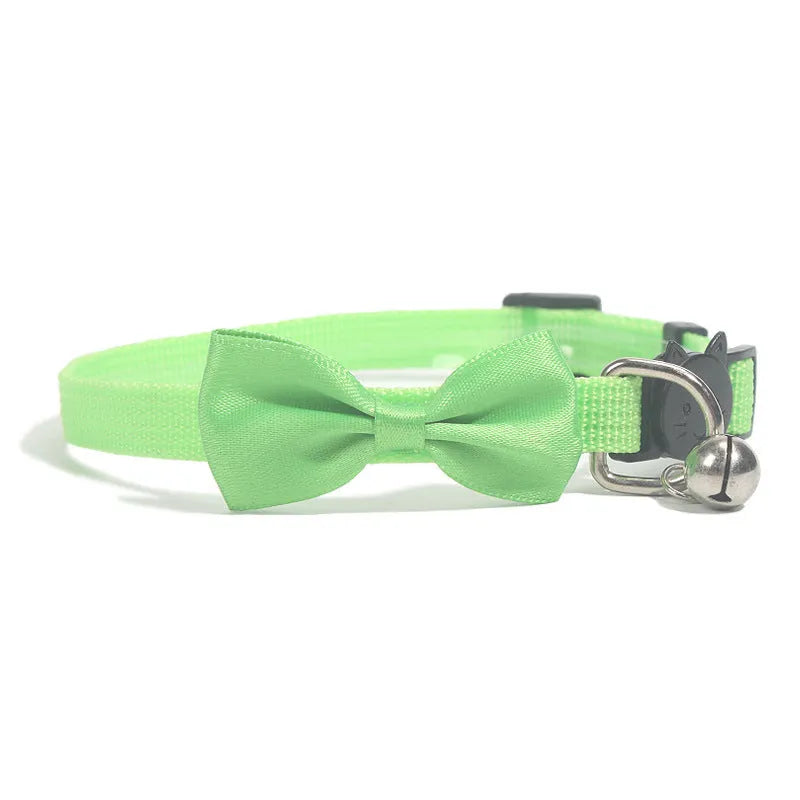 Adjustable striped nylon cat collar with a bell shown in multiple colours including red, blue, green, and pink.