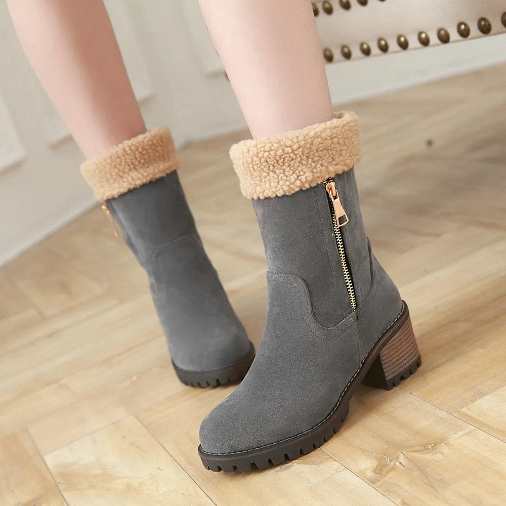 A pair of snow boots with a rubber sole and plush lining on a winter background.