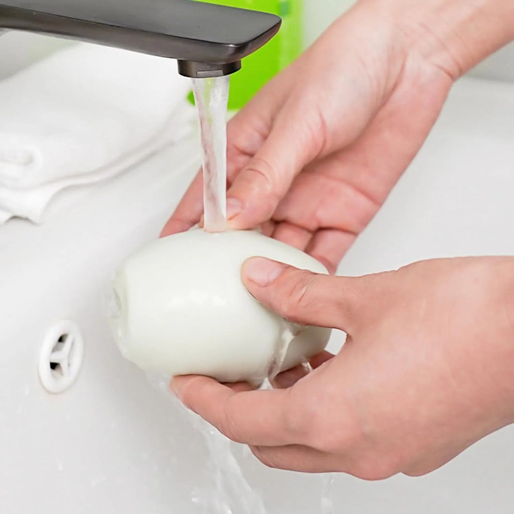 Green and white reusable gel lint roller ball for portable pet hair removal on clothing