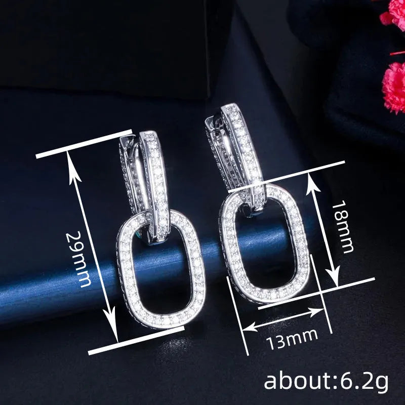 Pair of copper geometric U-shaped earrings with inlaid zircon in white gold colour