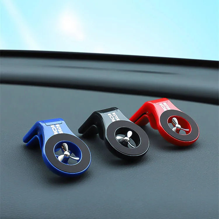 Black universal magnetic car phone holder clipped to a car air vent, holding a smartphone.