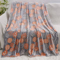 Children's cartoon flannel blanket in colourful design on bed
