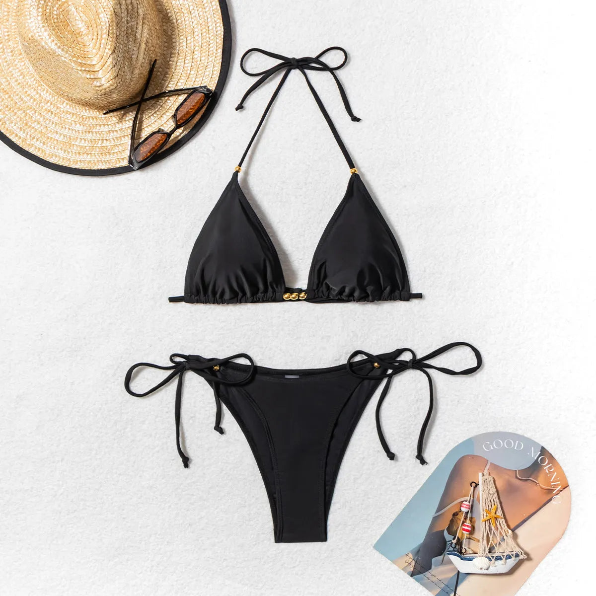 Black women's bikini swimsuit with metal bead split detail on a mannequin