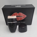 Black and white electric silicone lip plumper device with USB cable.
