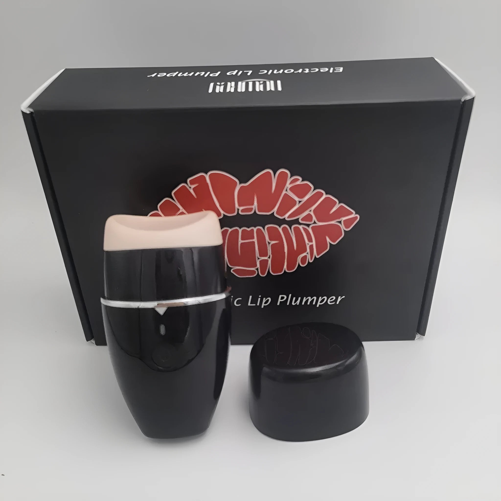 Black and white electric silicone lip plumper device with USB cable.