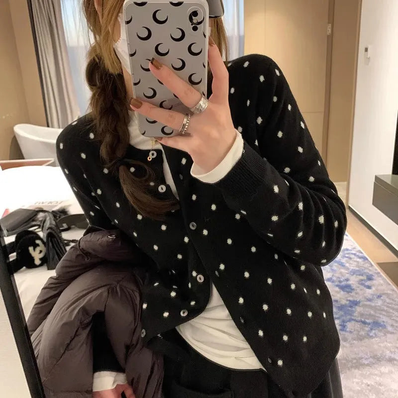 Grey Korean-style knitted cardigan with crocheted flower detail on mannequin
