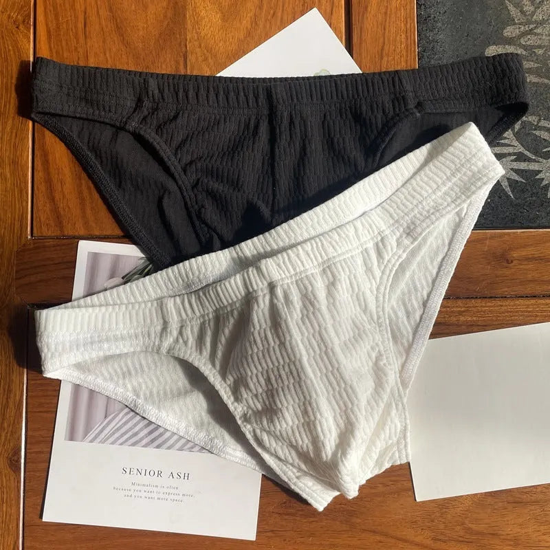Men's solid colour cotton triangle briefs in mid-waist style, shown in apricot and black colour options.